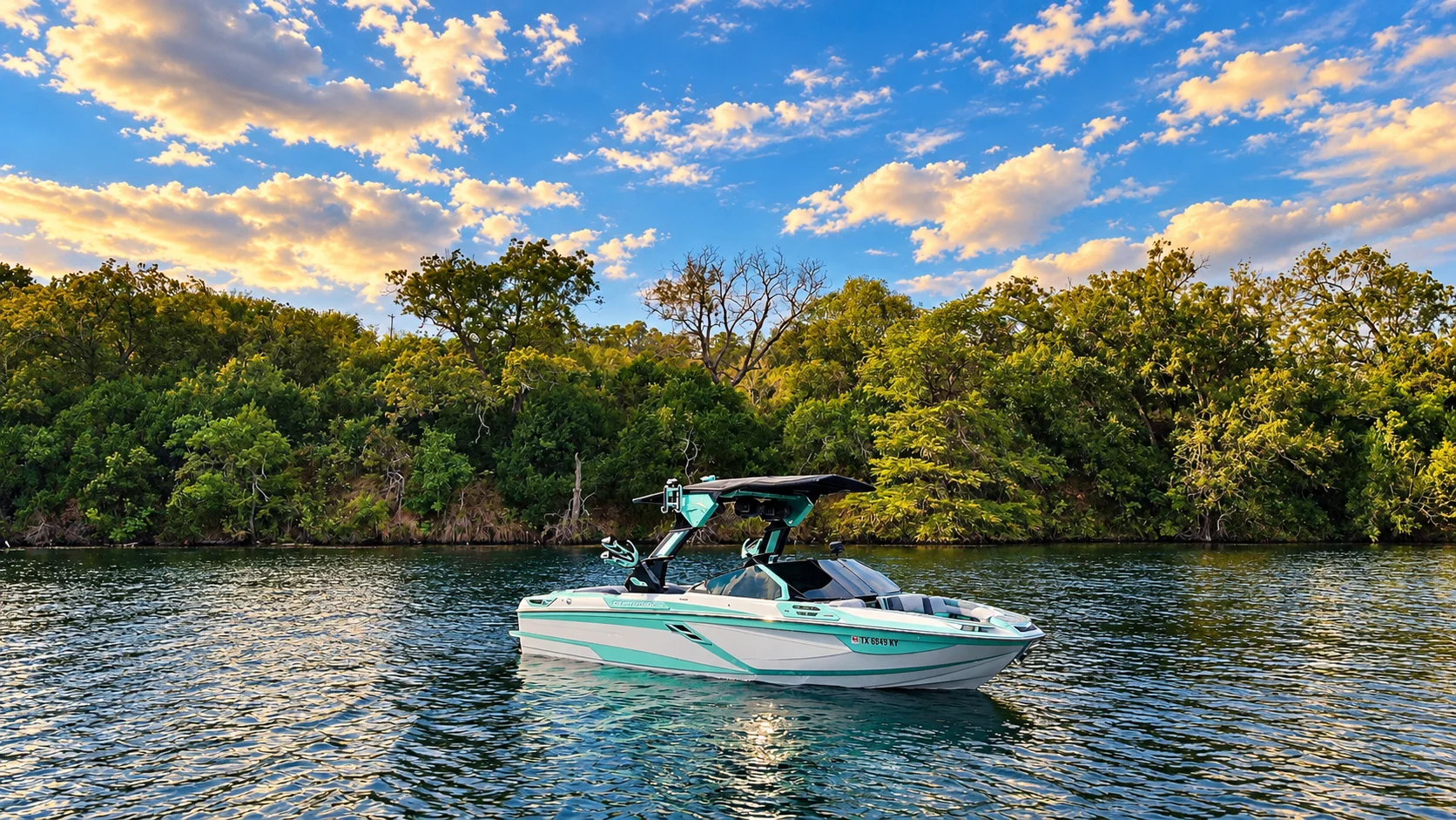 Mint and white Centurion floating beside a wooded shoreline
