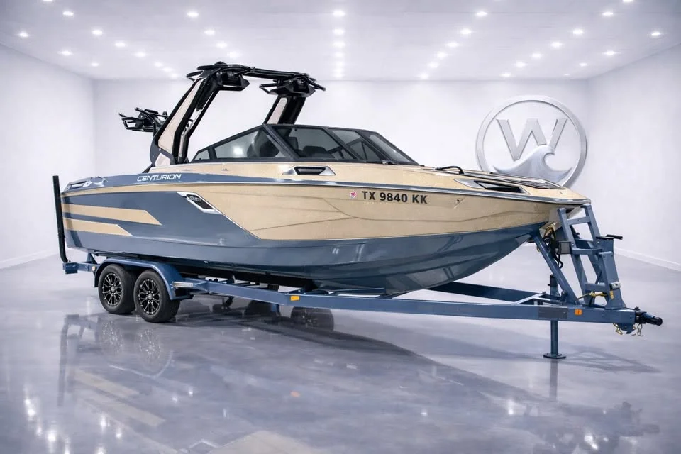 Gold and gray Centurion Ri245 on a trailer in a showroom
